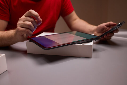 Testing new tablet. Conducting thorough review of new tablet and accessories. Systematically unboxing and evaluating tablet and stylus within neutral testing environment