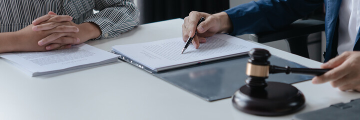 Attorney consulting clients in law firm office with professional discussion