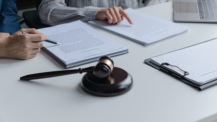 Attorney consulting clients in law firm office with professional discussion