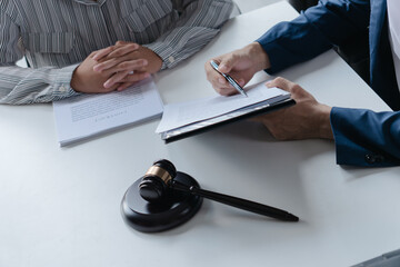 Attorney consulting clients in law firm office with professional discussion