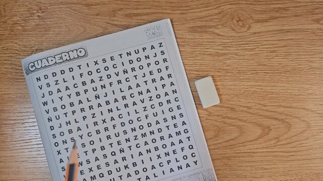 Person answering a word search puzzle, a brian game, aerial view