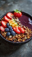 Colorful acai smoothie bowl with granola strawberries blueberries and melon