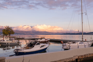 Sunset view of boats in the marina overlooking the mountains in Herceg Novi Montenegro