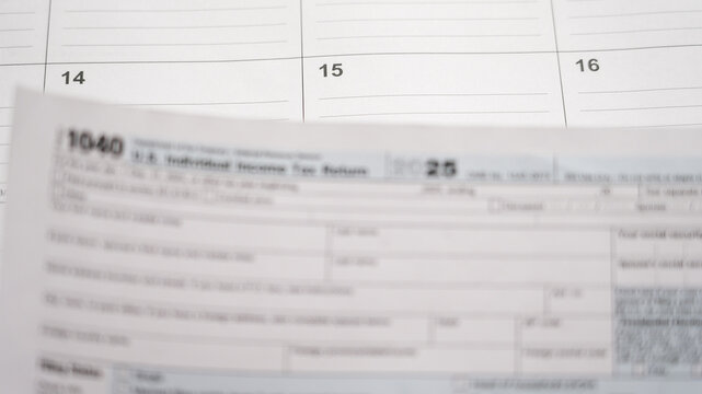 Preparing us individual income tax form 1040 for 2025, meeting the april 15 deadline on a calendar background