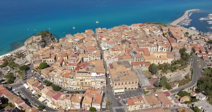 Panoramic aerial view of the historic center of Tropea, in province of Vibo Valentia, Calabria, southern Italy. The town is perched on a cliff overlooking the Mediterranean sea. Italian cityscape.