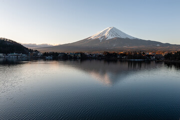 Mount Fuji on a bright winter morning, as seen from across lake Kawaguchi, and the nearby town of Kawaguchiko.