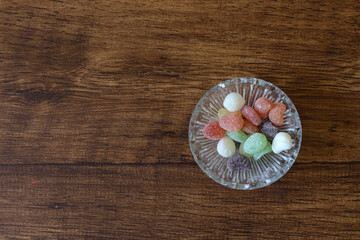 木材背景のガラス容器にいれたドロップ