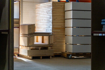 Manufacturing workshop scene with stacked wooden bed frames