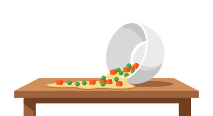 A white bowl is tipped over, spilling cooked mixed vegetables like peas and carrots onto a wooden table surface.