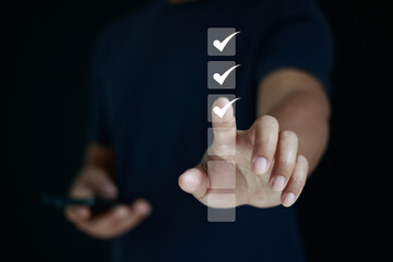 Businessman hand touching virtual checklist with checkmark icons, concept of task completion, quality control, approval process, project management, productivity, workflow, and business success.