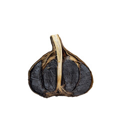Black garlic cut in half on white background