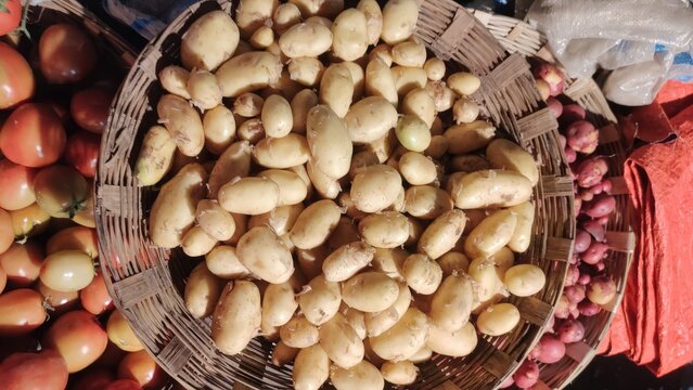 Small light-skinned potatoes in woven basket ready for purchase at market