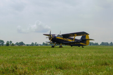 Vintage biplane aircraft on grassy airfield © anetaduk