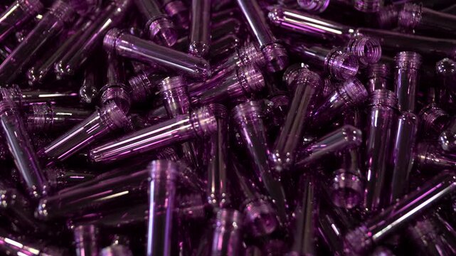 Purple PET preforms for plastic bottle manufacturing process.