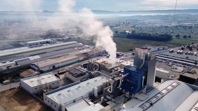 Factory emites smoke pollution contamination against a spanish city 
