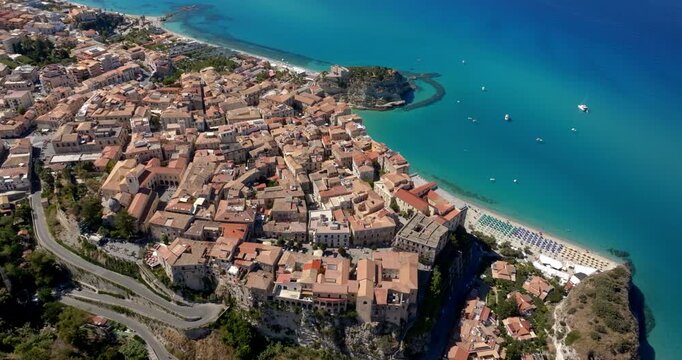 Panoramic aerial view of the historic center of Tropea, in province of Vibo Valentia, Calabria, southern Italy. The town is perched on a cliff overlooking the Mediterranean sea. Italian cityscape.