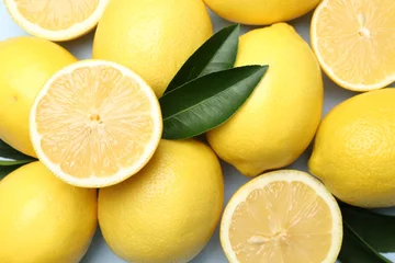 Fotobehang Eten Ripe lemons and leaves on light background, flat lay  © New Africa