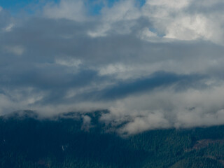 Obraz premium Moggy? No—Correct: Misty Cloudy Mountains Over Forested Ridge Near Howe Sound, BC, Canada
