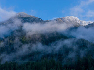 Snowy Mountain Peaks Above Foggy Forests in Howe Sound, BC, Canada