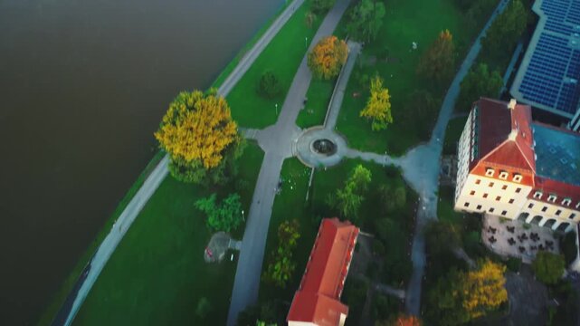 At dawn in Dresden's Old Town, A shot that pans upward from below and show a train crosses the bridge over the Elbe River, with the Yenidze Theater and Heinz-Steyer-Stadion in the background and a bir