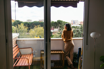 Fototapeta premium Woman enjoying morning on apartment balcony