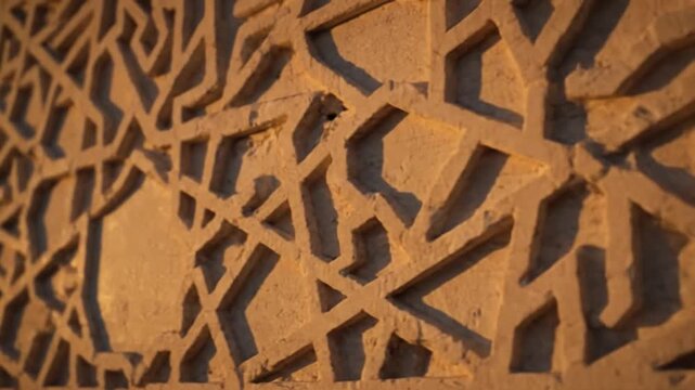 Intricate geometric patterns carved into a textured stone surface, showcasing traditional artistry and architectural detail