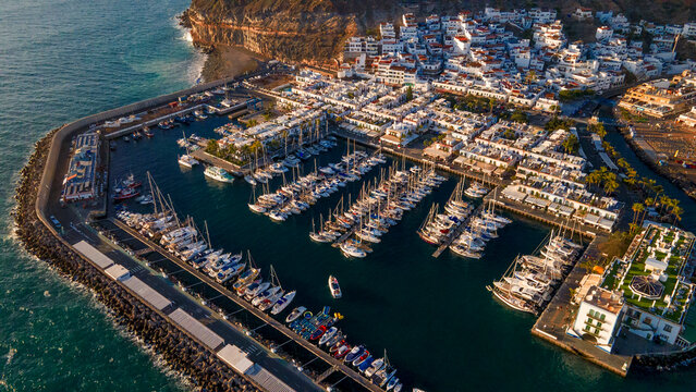 Sunset glow over the white houses and the marina in Puerto de Mogan