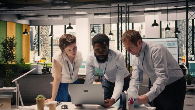 Corporate professionals, analyzing charts, KPI dashboards on laptop, collaboration for planning, resource allocation, and productivity, modern office workspace, diverse workers.