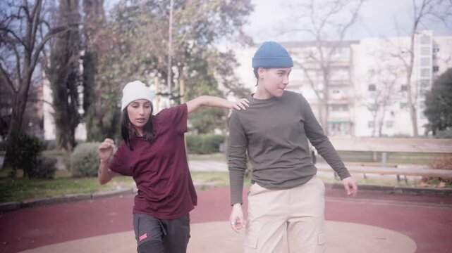 Woman freestyling hip hop dance with beatboxer friend