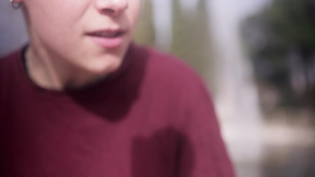 Hispanic woman beatboxing and freestyling in a city park