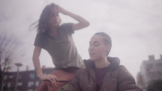 Talented hip hop woman beatboxing and dancing freestyle in urban park