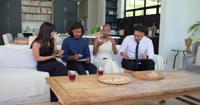 Four adults sitting on sofa after meeting, picking pizza slices, catching up, passing stemmed glass