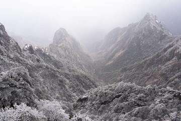 Mt Huangshan, China: Dramatic view of the frozen valley from the top of the Yellow mountain, Mt Huangshan in China in a cold winter day.