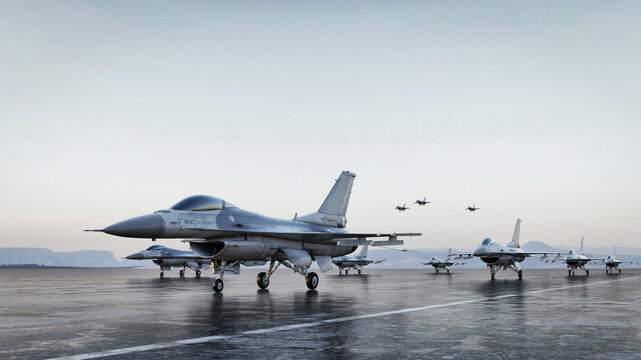 Squadron of military fighter jets on the airfield runway at dawn.