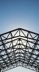 Fototapeta premium Metal Truss Structure Under Clear Blue Sky.