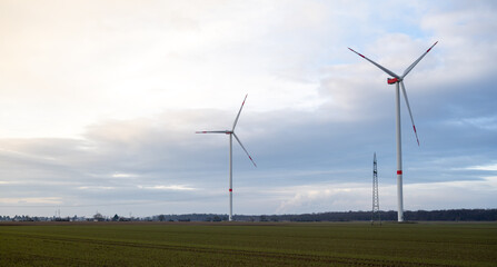 Two wind turbines are standing in a field