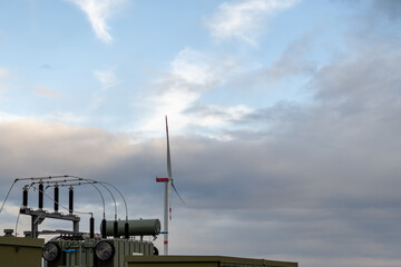 A wind turbine is on top of a power station