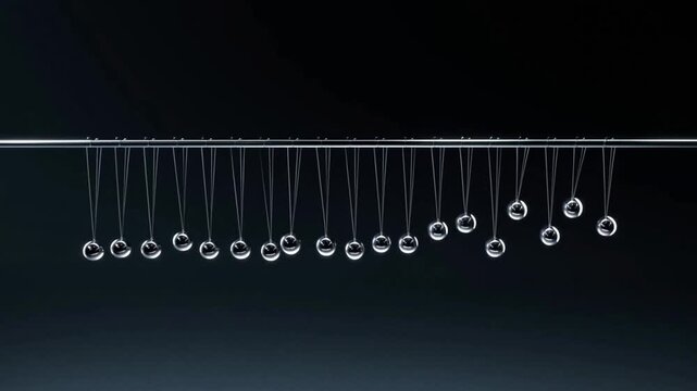 Newton&rsquo;s Cradle with Glass Spheres &ndash; Kinetic Energy Transfer in Slow Motion on Dark Background
