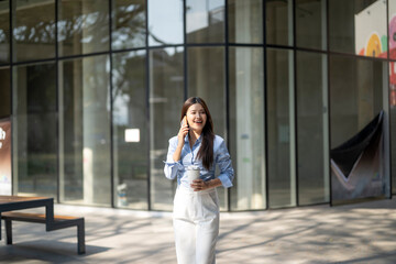 Professional woman walking and talking on smartphone