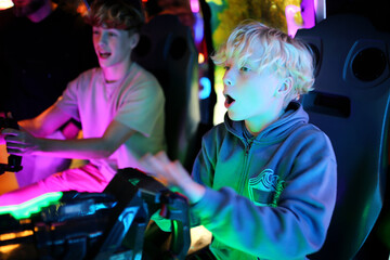 Kids Playing Shooting Video Game in Neon Light Arcade