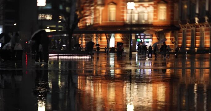 A night cityscape of the rainy urban street at the business town in Tokyo