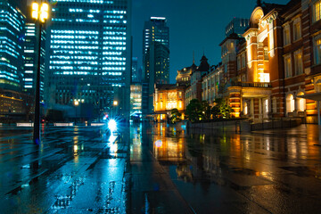 Naklejka premium A night cityscape of the rainy urban street at the business town in Tokyo