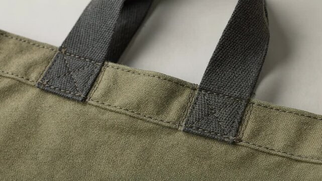 Medium shot showcasing reinforced stitching on durable bag handles with detailed bar tacks for enhanced strength and longevity.