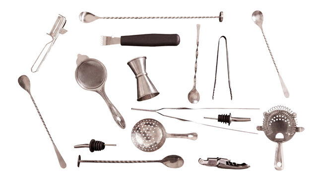 Top-down view of a professional bar tool set with stainless steel spoons, strainers, and jiggers on a white background.