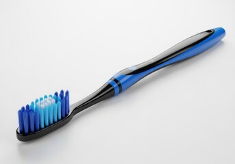 Blue and black toothbrush with bristles on a light gray surface