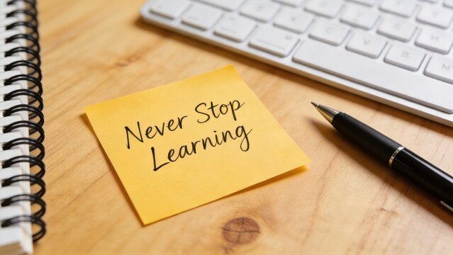Motivational sticky note with never stop learning message on wooden desk,education mindset,personal growth,career development and lifelong learning inspiration