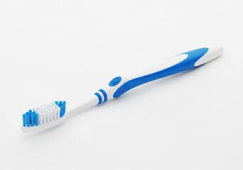 Blue and white toothbrush on a plain surface for oral care