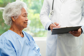 Doctor taking care, help and encourage Asian elder senior woman patient in clinic hospital.