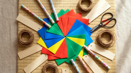 Colorful paper craft supplies arranged on a tatami mat scissors twine