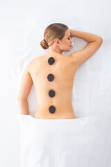 Young woman getting massaging treatment over white. Spa, healthcare and recreation concept.